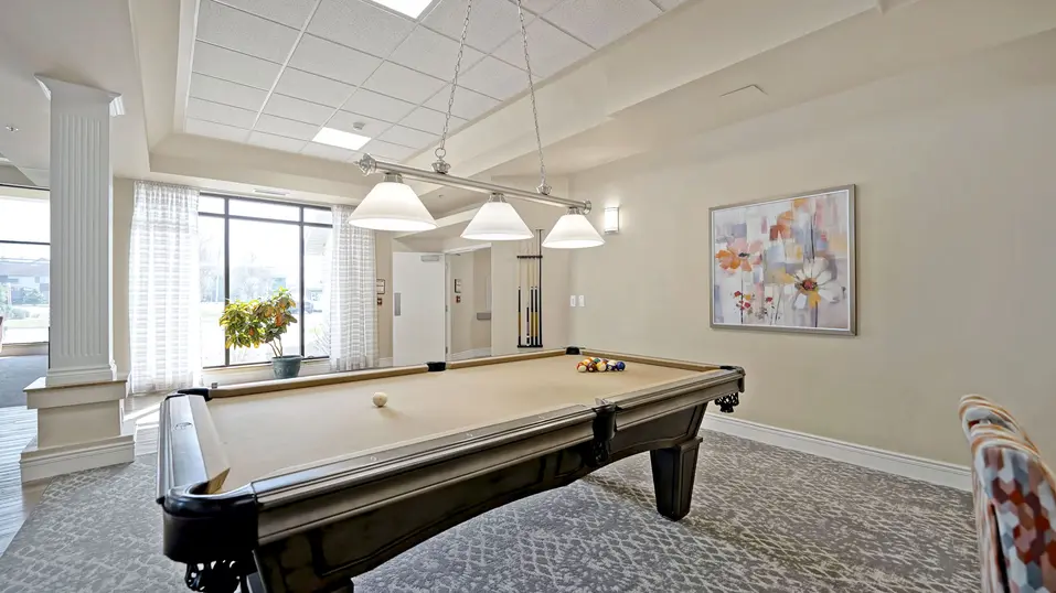 Activity room with pool table at Chartwell Belle River