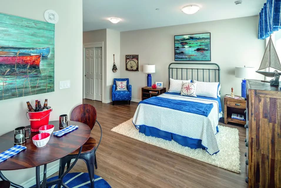 Model suite of bedroom with table and chairs at Chartwell Stoney Creeek