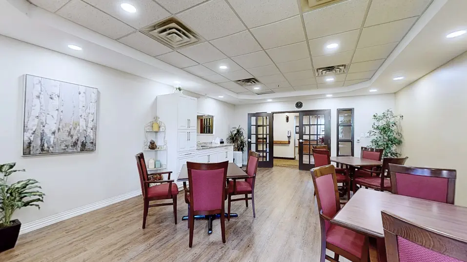 Sitting space with several tables and chairs at Chartwell Amherstburg