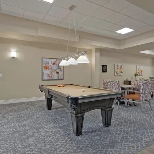 Activity room with pool table at Chartwell Belle River
