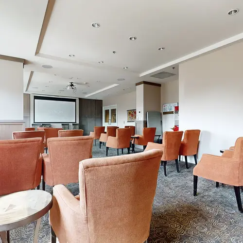 Theatre with orange chairs at Chartwell Stoney Creeek