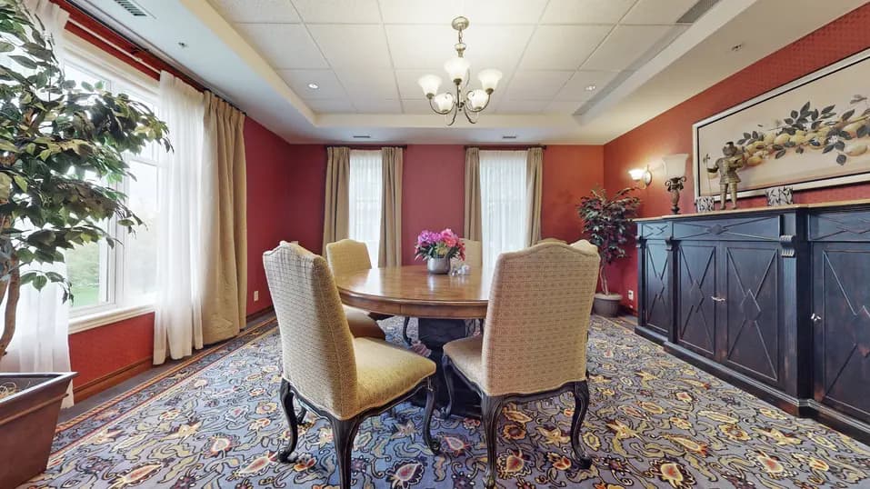 Room with table and chairs at Chartwell Strathroy