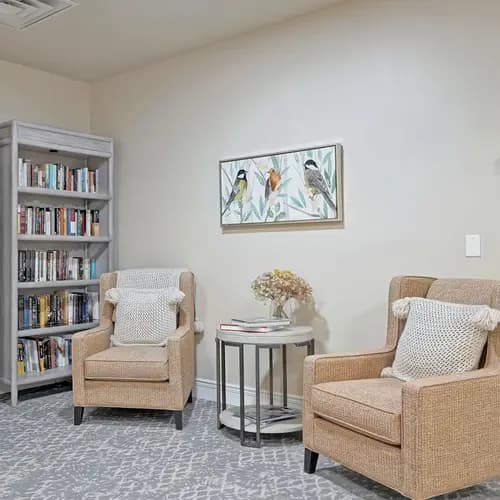 Library with wing back chairs at Chartwell Belle River