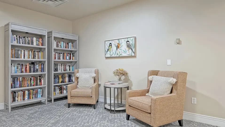 Library with wing back chairs at Chartwell Belle River