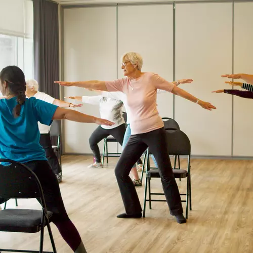 A group of seniors are taking Chair Yoga class at Chartwell residence / Un groupe de personnes âgées suit un cours de yoga sur chaise à la résidence Chartwell