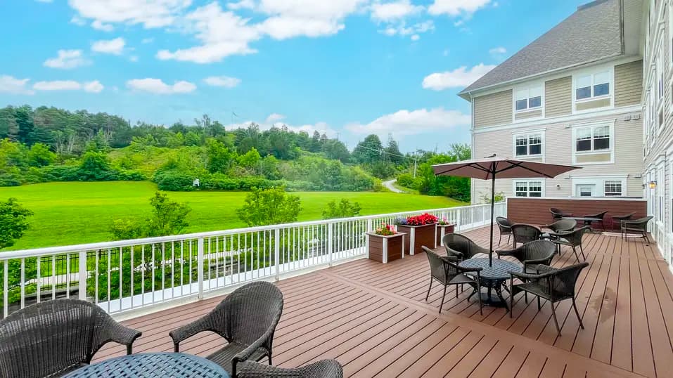 Patio with table, chairs and umbrella at Chartwell Dufferin Centre