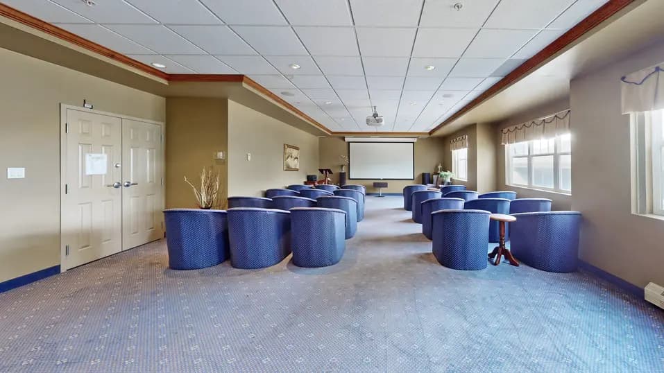 Theatre with blue chairs at Chartwell Royal Oak Village