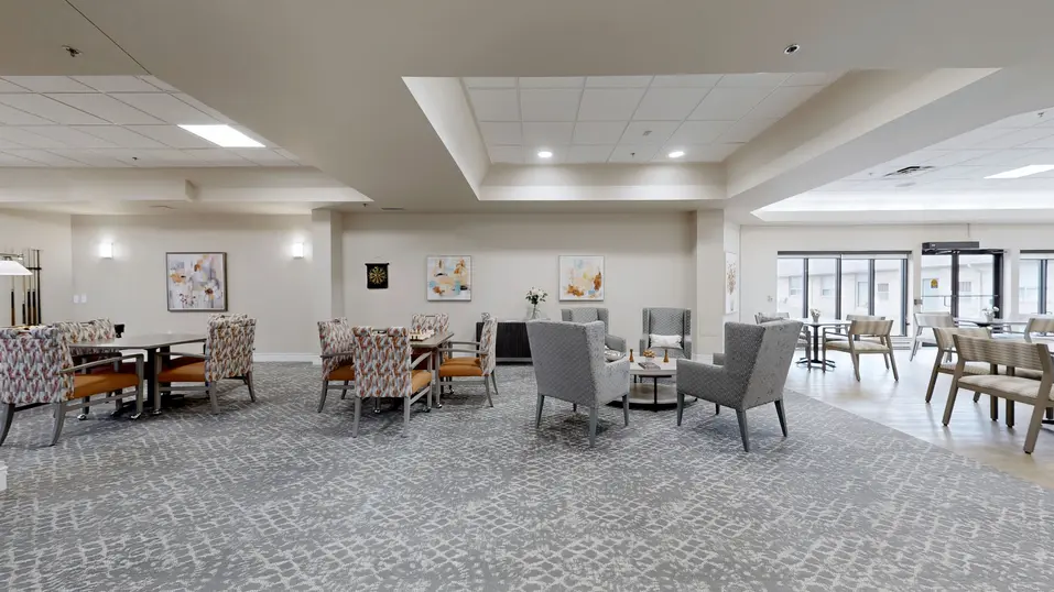 Activity room with table and chairs at Chartwell Belle River