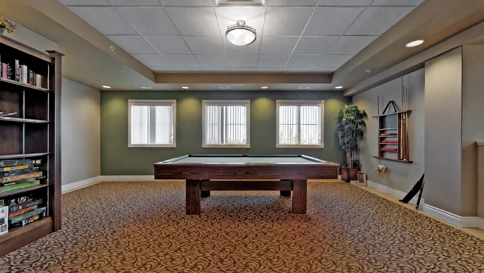 Activity room with billard table at Chartwell Lethbridge Gardens