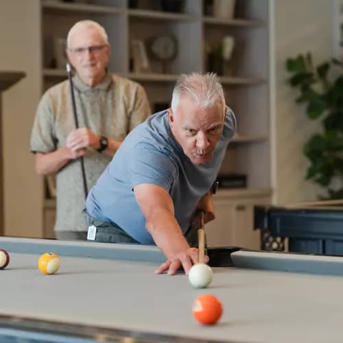 Senior men playing pool
