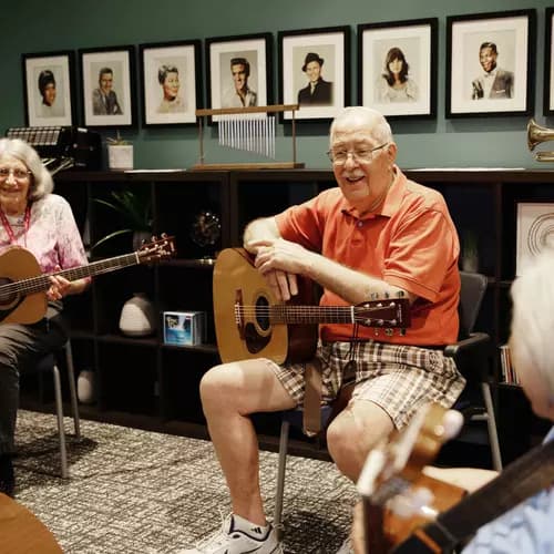 Senior resident group getting ready to play guitar