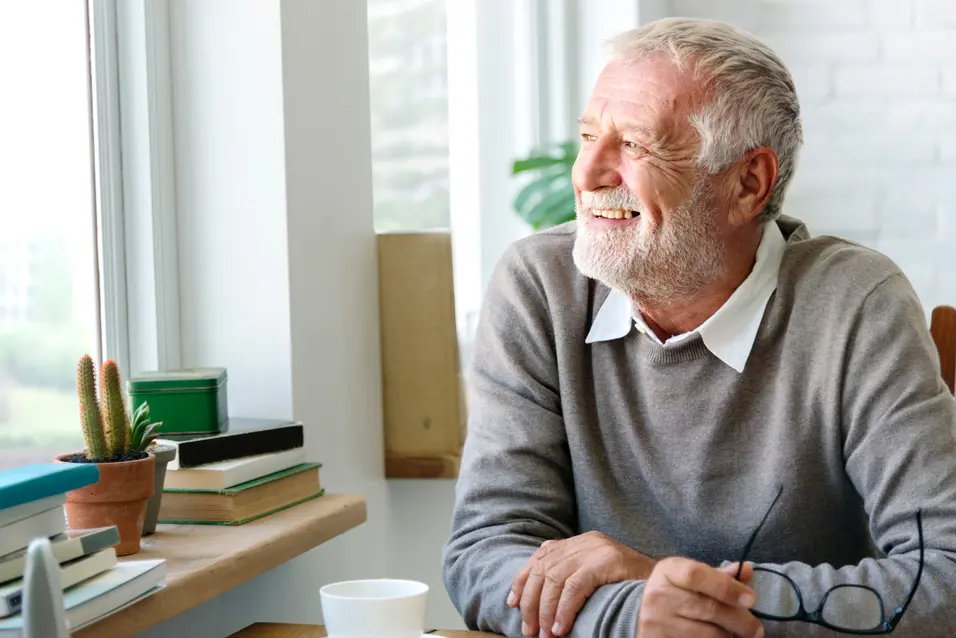 Senior Adult Looking Outside WIndow Relax Concept