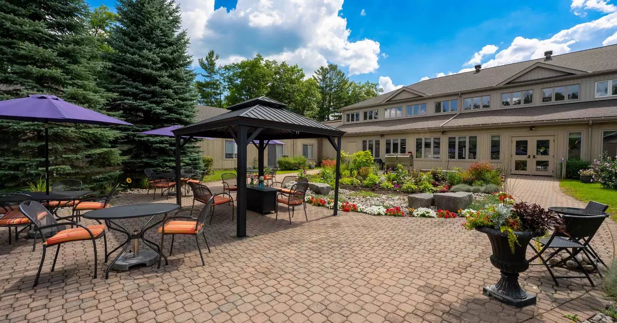 Patio and walking paths at Chartwell Whispering Pines Retirement Residence.