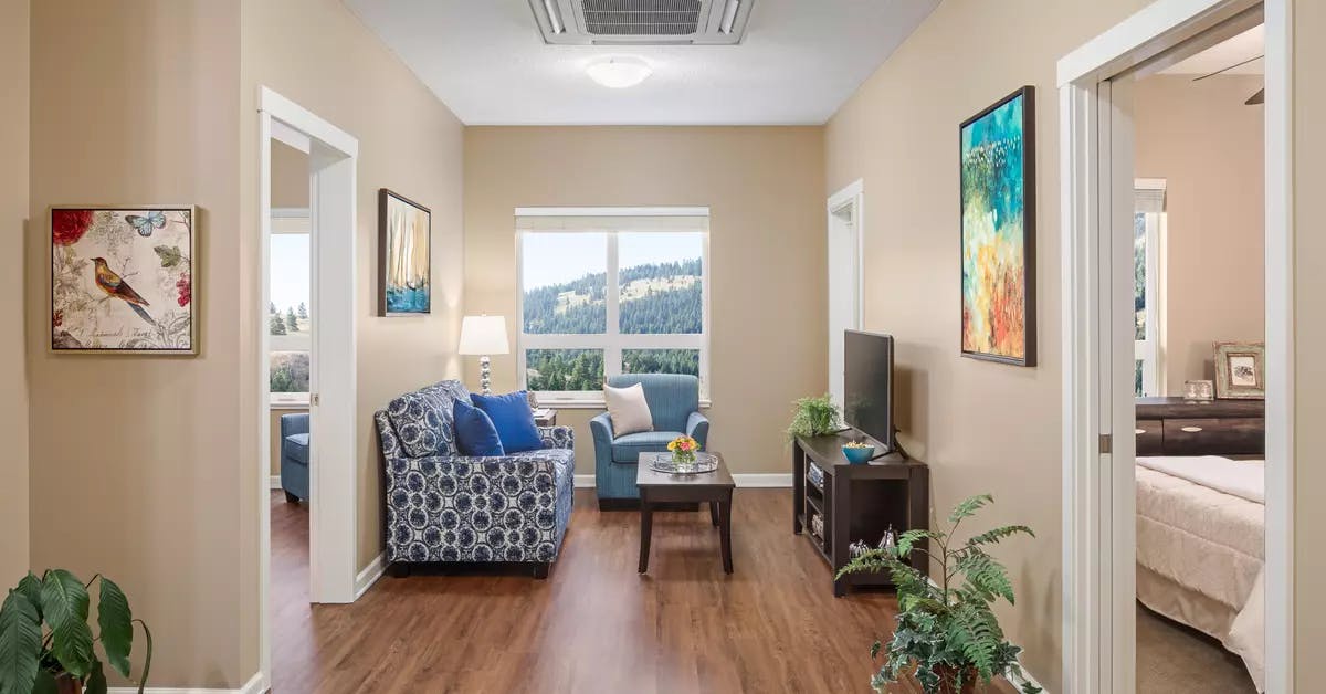 bright and sunny living room with mountain views at chartwell ridgepointe retirement residence