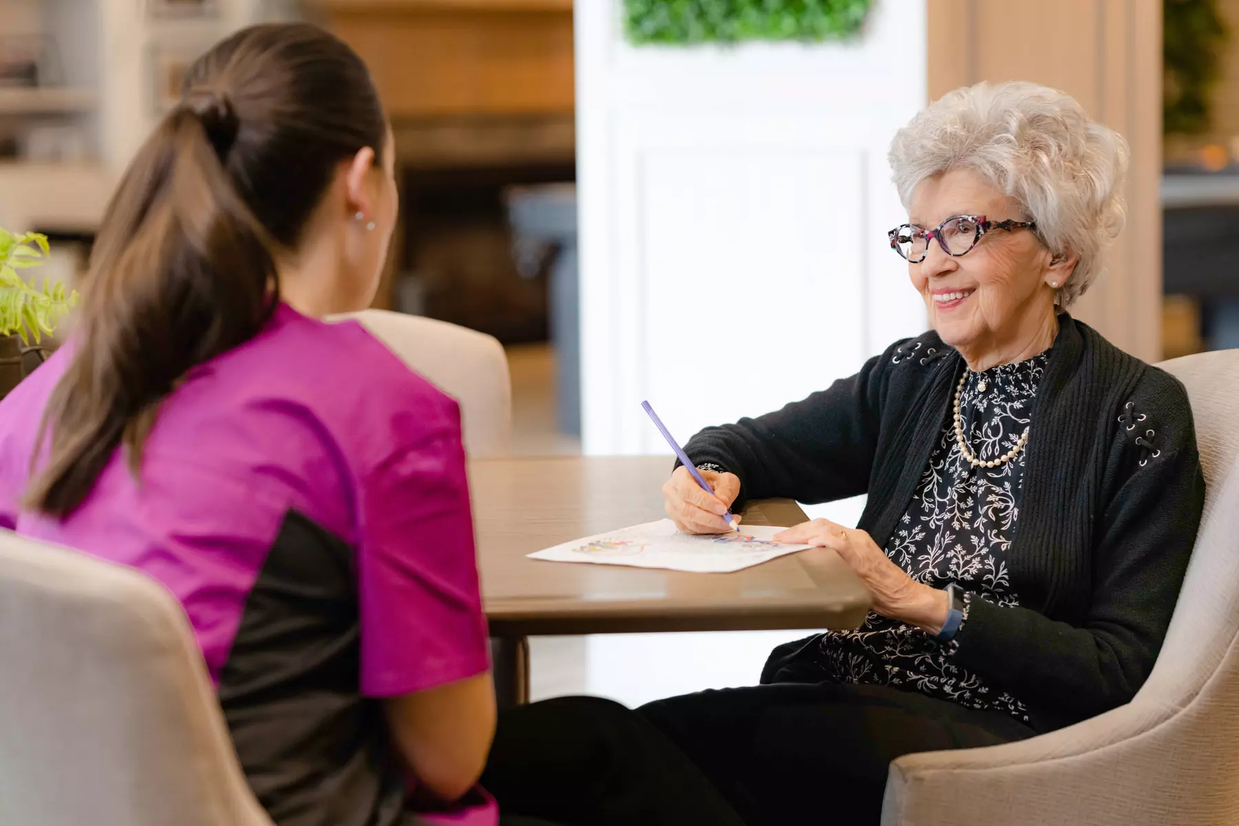 Chartwell staff chatting with the senior resident