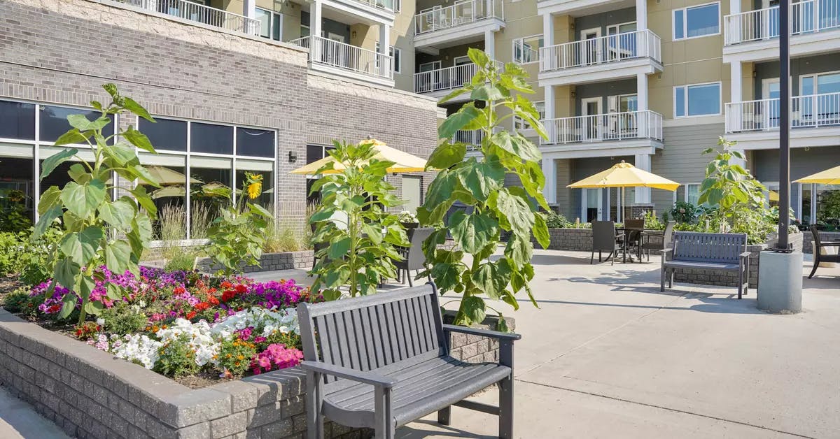 beautiful courtyard with lush gardens at chartwell heritage valley retirement residence