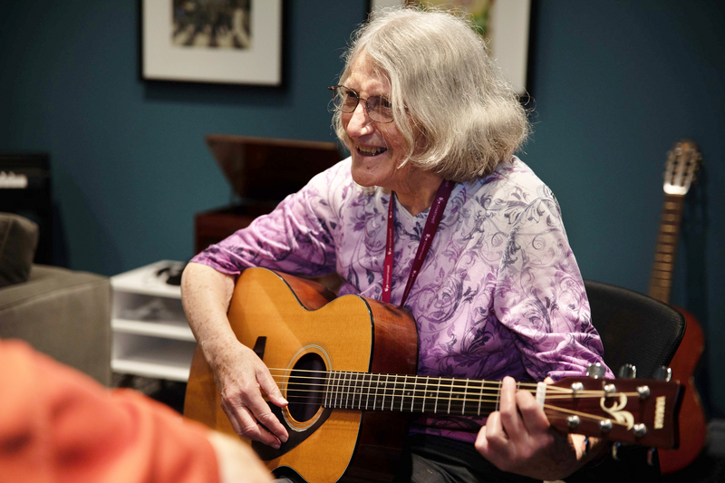 Chartwell Senior resident playing guitar