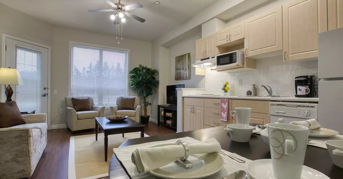 beautiful kitchen and living room at chartwell colonel belcher retirement residence 