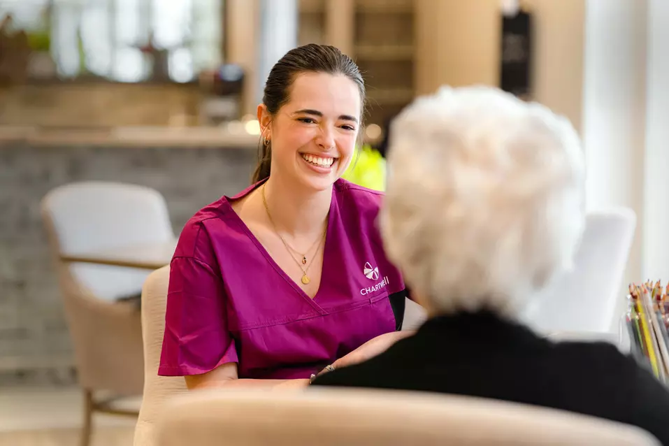 Chartwell staff chatting with the senior resident