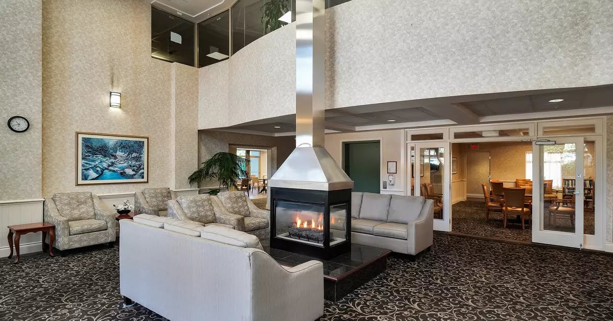 inviting and warm fireside lounge at chartwell crescent gardens retirement residence