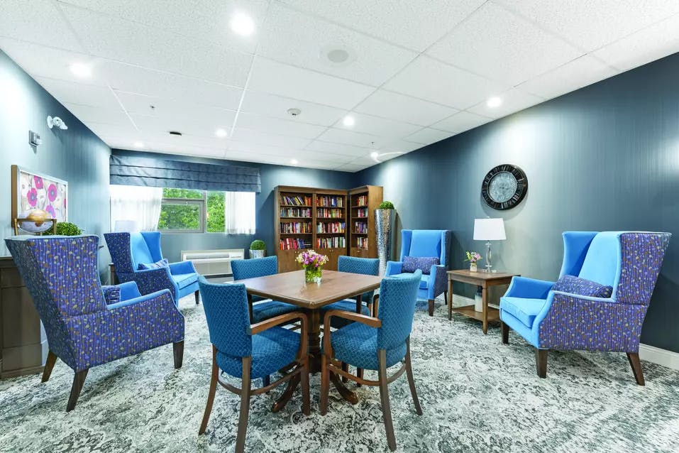 Chartwell Avondale Retirement Residence library with tables for games and chairs for reading