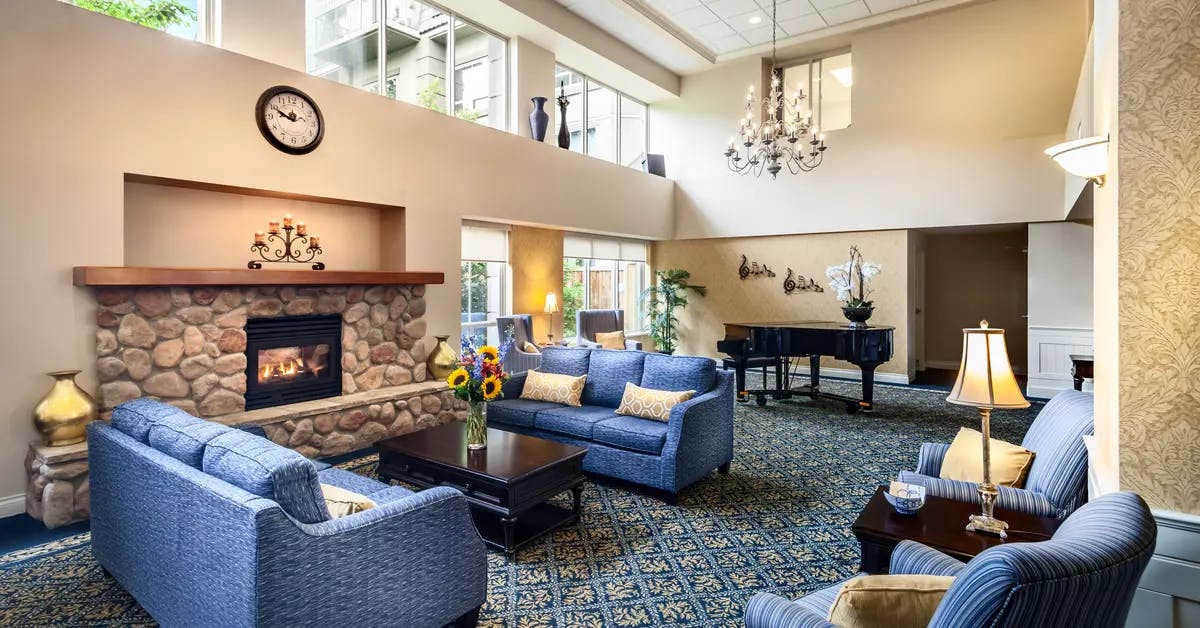 warm and cozy fireside lounge at chartwell langley gardens assisted living