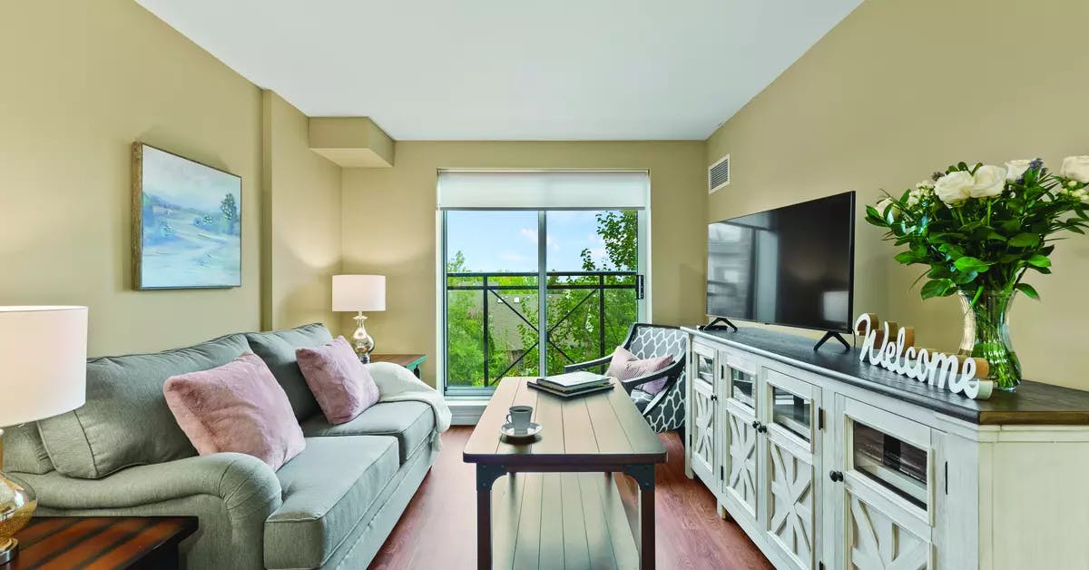 Suite living room with a view at Chartwell Hollandview Trail Retirement Residence.