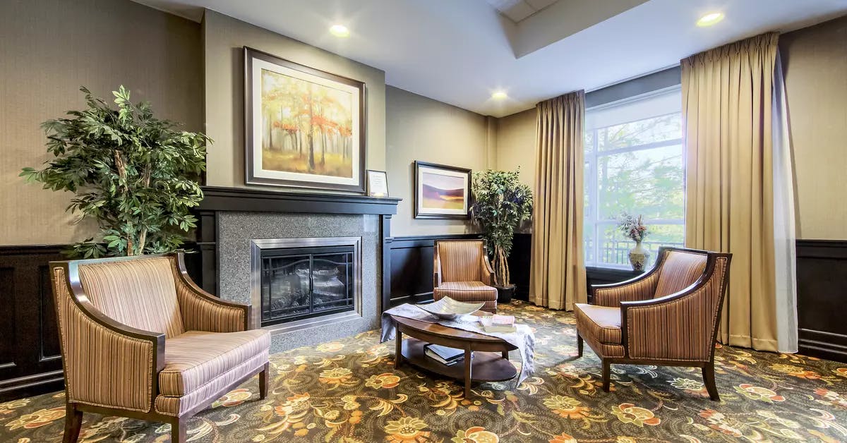 Chartwell Westmount's common area fireplace and comfortable chairs