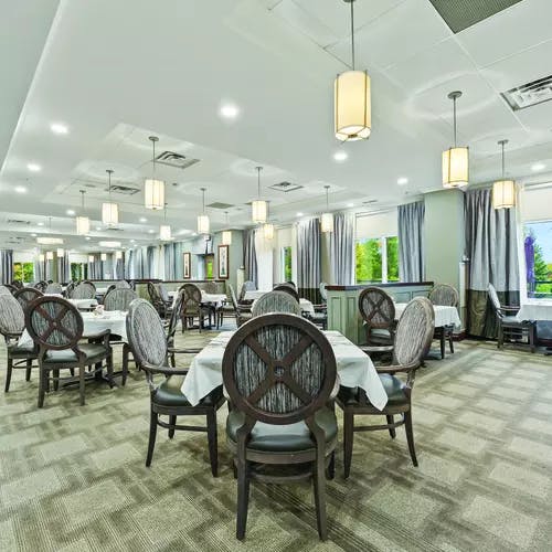 Open and bright dining room at Chartwell Hollandview Trail Retirement Residence.