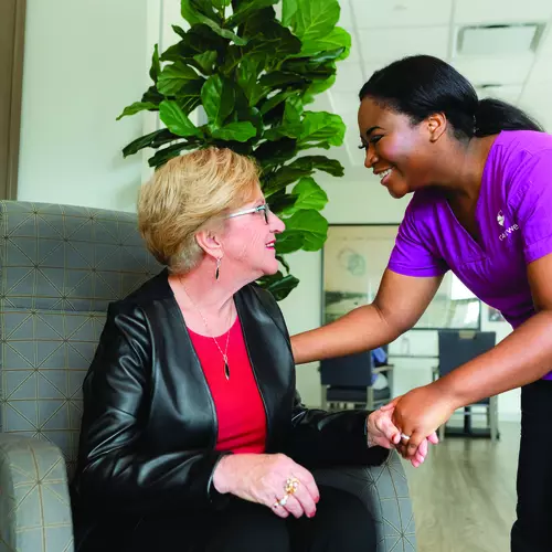 Friendly greeting between a Chartwell staff and resident / Accueil amical entre un membre du personnel de Chartwell et un résident