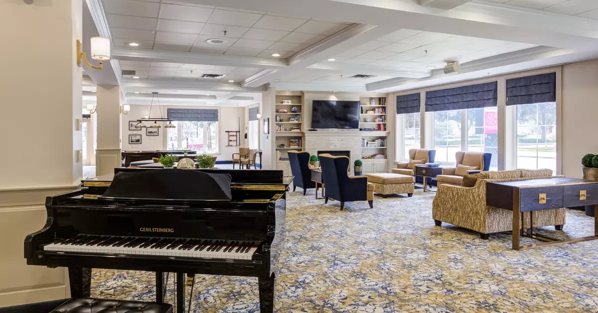 Piano lounge at Chartwell Queen's Square Retirement Residence