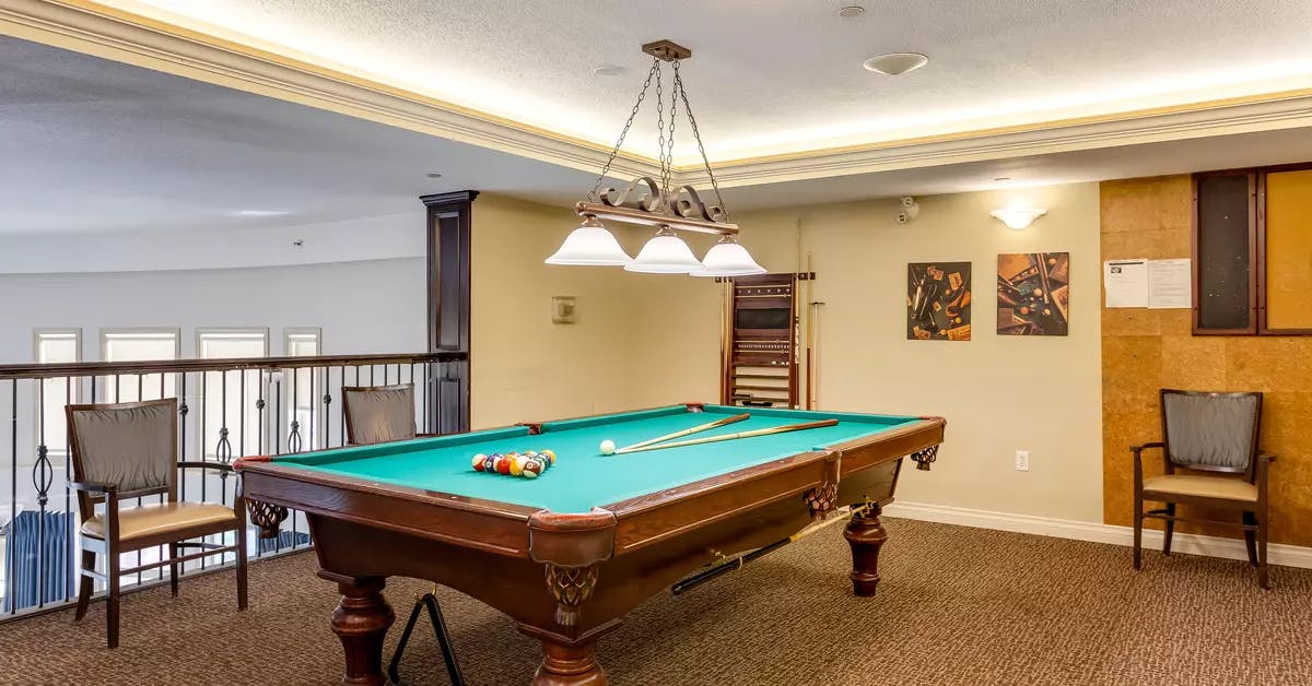 pool table and sitting area at chartwell colonel belcher retirement residence