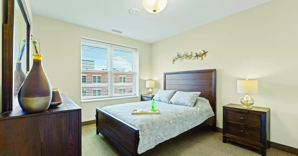 Chartwell Allandale Station Retirement Residence  bedroom with big windows. 