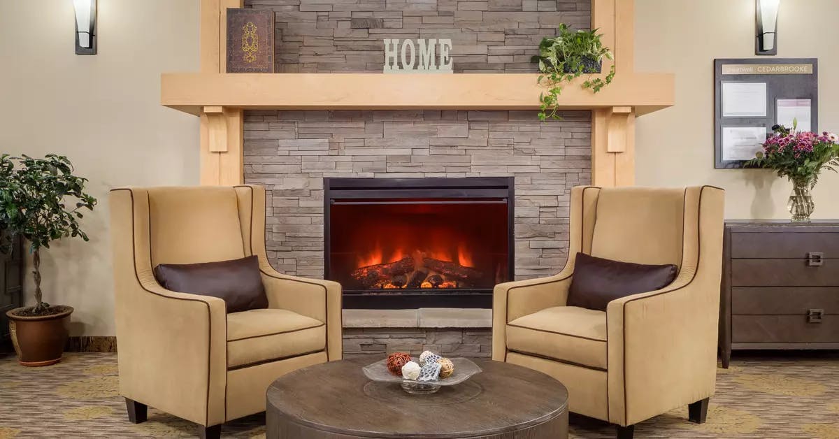 warm and cozy fireside lounge at chartwell cedarbrooke retirement residence