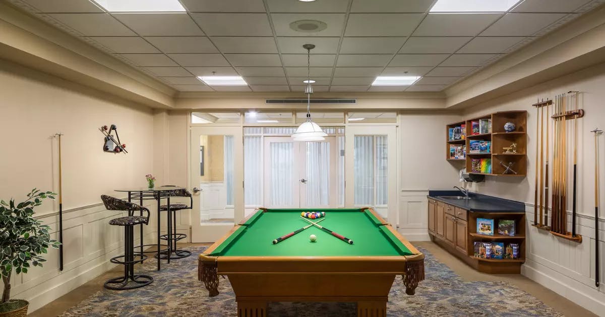 pool table lounge with stools at chartwell langley gardens assisted living