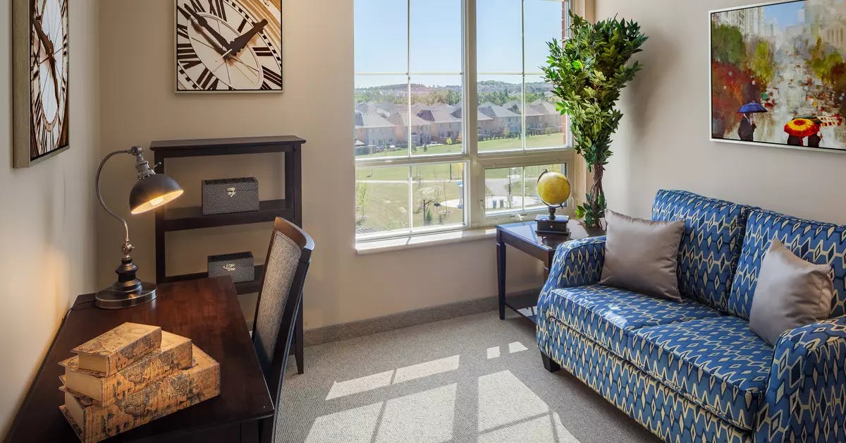 Bright suite living room at Chartwell Valley Vista Retirement Residence 