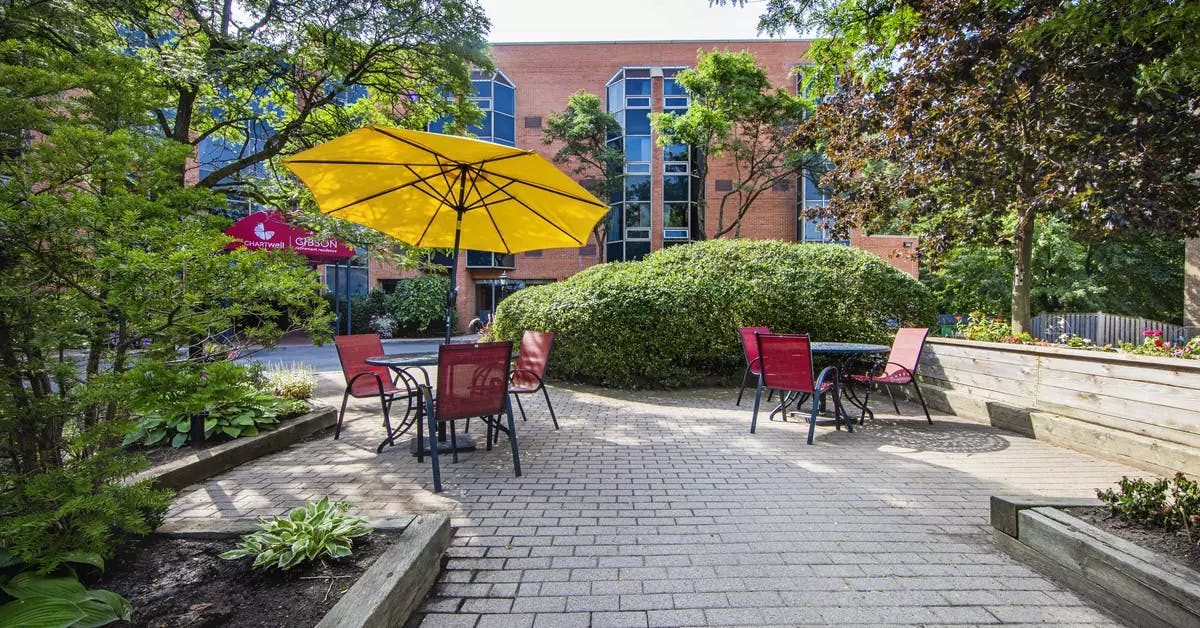 Chartwell Gibson's exterior patio with tables and umbrellas