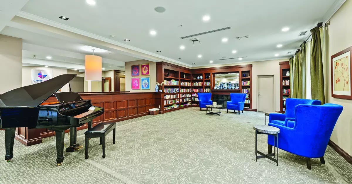 Open and bright library at Chartwell Hollandview Trail Retirement Residence.