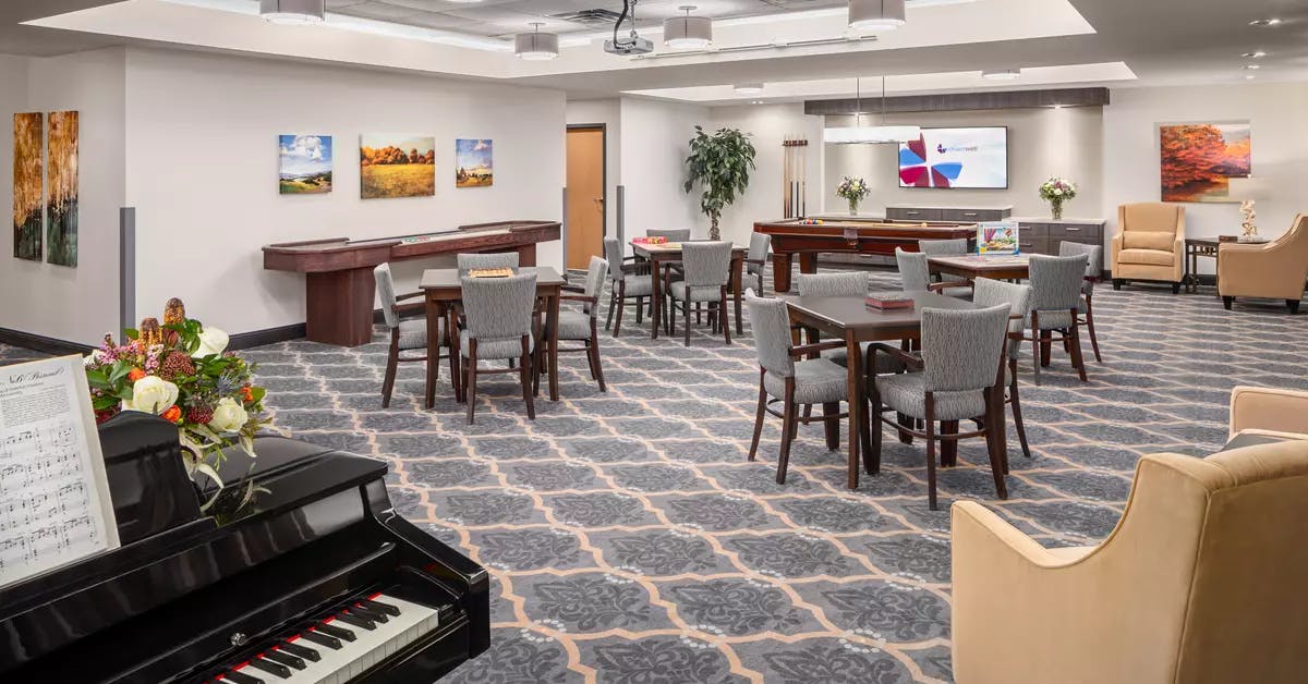 spacious bistro with a piano at chartwell fountains of mission retirement residence