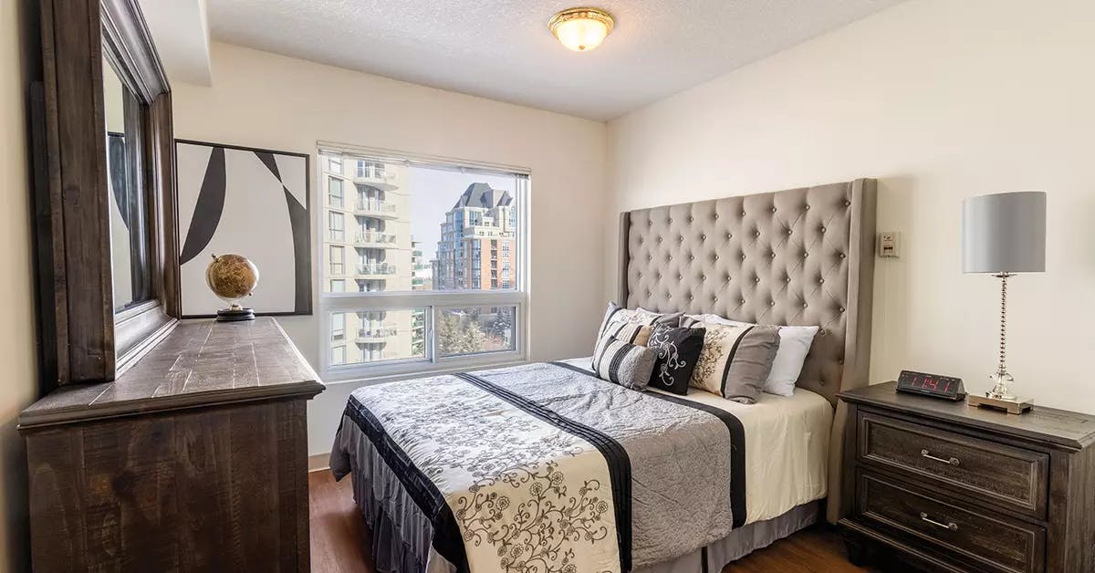comfortable bedroom with excellent city views at chartwell eau claire care residence