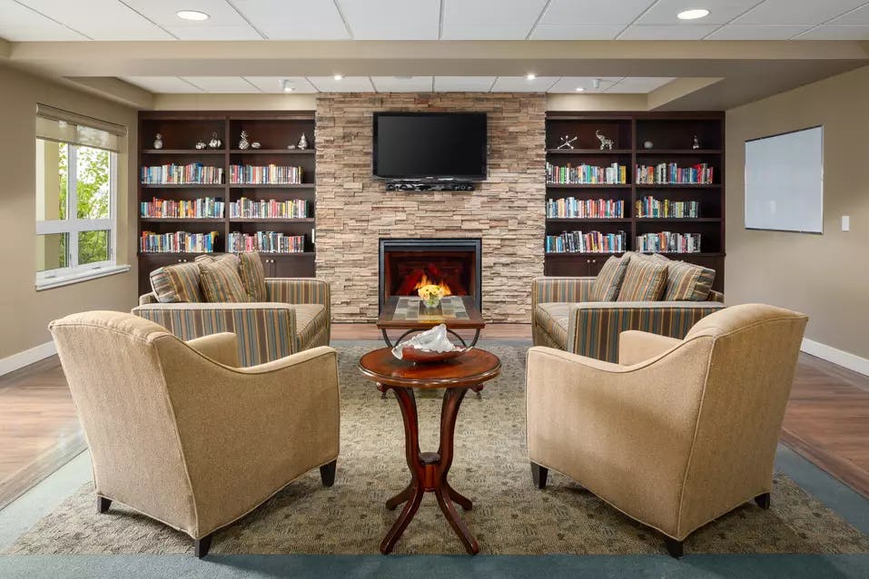 warm and inviting fireside lounge at chartwell ridgepointe retirement residence